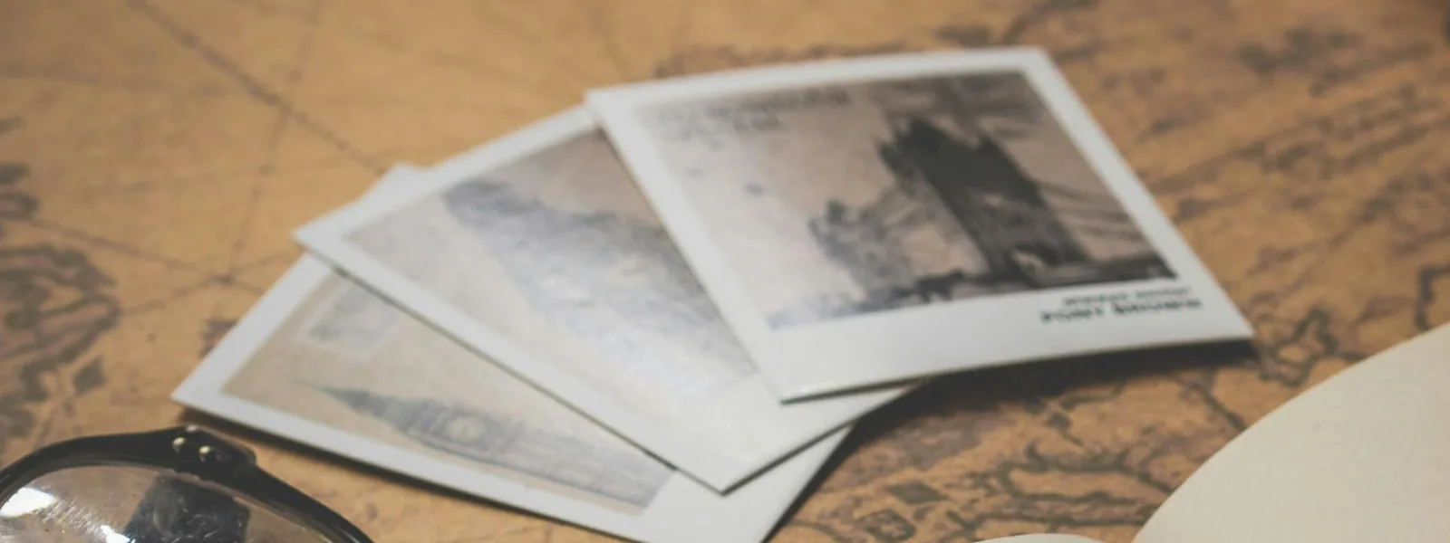 Photos on an old map, mood image for the Images block